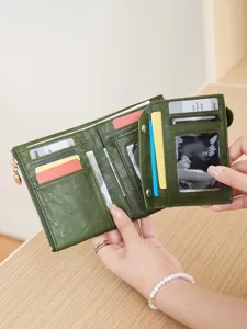 Green women's short trifold wallet with multiple card slots, coin pocket and secure snap.