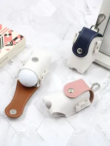 Detail view of portable leather golf ball pouch with contrast color design and metal hook.