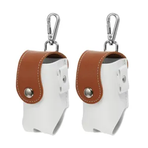 Detail view of the portable mini golf ball pouch, featuring white and brown leather design.