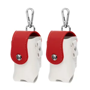 Closeup of the mini golf ball pouch featuring a secure snap button, durable leather, and metal hook.