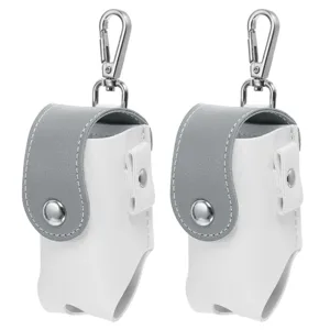 Detail view of the white and grey leather golf ball pouch with metal clip for outdoor sports.