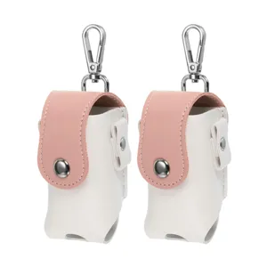 Detailed view of portable mini golf ball pouch, pink and white colorblock leather with metal hook.