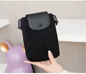 Black plush crossbody phone bag with leather flap, stylish mini shoulder bag for women.