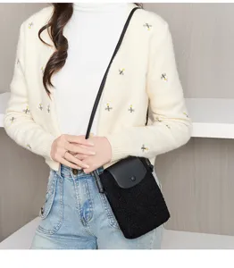 Black plush crossbody phone bag with leather flap detail, perfect for casual daily wear.