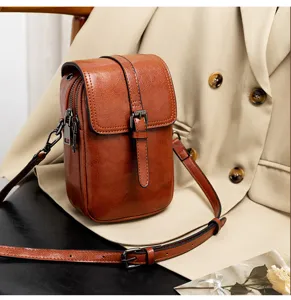 Vintage PU leather women crossbody bag, retro vertical small shoulder bag with double zipper.