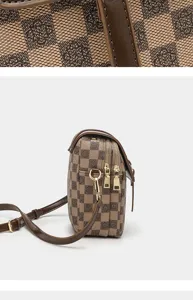Detail view of the retro printed leather crossbody phone bag with double zippers and metal hardware.