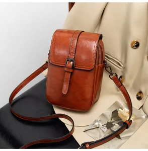 Detail view of the vintage brown PU leather crossbody bag, showing double layer and sleek texture.