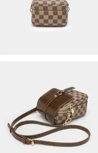 Detailed view of retro checkerboard crossbody phone bag with dark brown leather flap and zip.