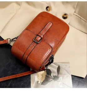 Detail view of brown vintage PU leather crossbody bag, dual-layer design, elegant retro style.
