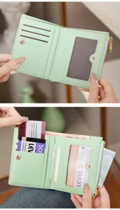 Close-up detail of mint green folding wallet showing multiple card slots and cash compartments.