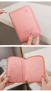 Detailed view of pink travel passport wallet with multiple card slots and secure zipper closure.