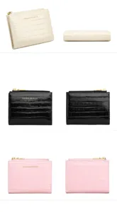 Close-up detail view of women short wallet with crocodile pattern, bi-fold design and zip pocket.