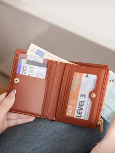 Stylish women's short bi-fold wallet with zipper coin pocket and card slots for daily use.