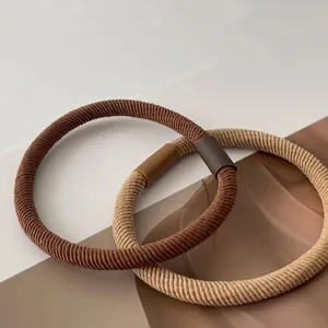 Close-up view of basic twill hair ties with secure connecting bands for daily styling.