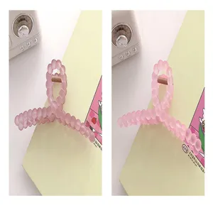 Gros plan sur les détails de la pince à cheveux rose givrée à bulles, design minimaliste.