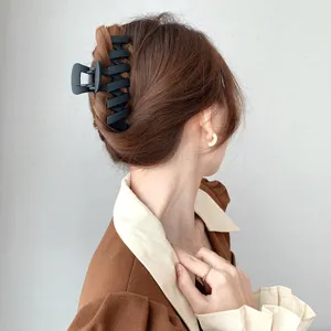 Matte black large hair claw clip, minimalist hollow wavy hair accessory for elegant styling.