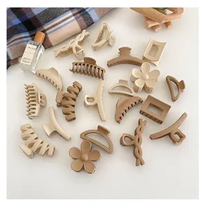 Details of matte milk coffee hair claws set, aesthetic flat lay with chic styling accessories.