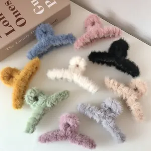 Fluffy plush hair claw clips in assorted colors, soft winter hair accessories for elegant styling.