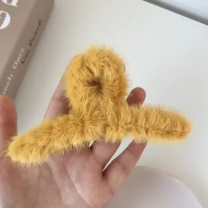 Yellow plush hair claw clip, soft fluffy winter hair accessory for women bun styling.