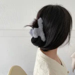Cozy plush hair claw clip in grey faux rabbit fur, perfect autumn winter hair accessory style.