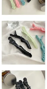 Detail view of colorful hairdressing duckbill clips for styling, makeup, and sectioning hair.
