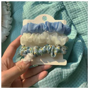 Chic 3-piece floral scrunchies set made of soft chiffon fabric with elegant blue and white tones.