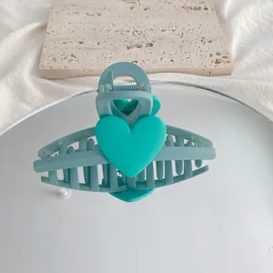 Detail shot of the macaron green heart hair claw clip, matte finish hair accessory showcase.