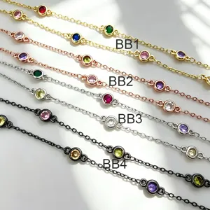Close-up detail of DIY bezel-set cubic zirconia station chains in multi-color metal finishes.