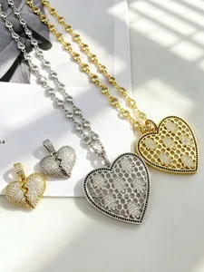 Detailed view of heart pendant necklaces and broken heart charms with sparkling zircon stones.