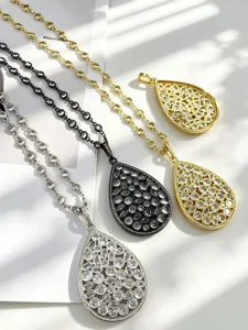 Elegant teardrop pendant necklace set with sparkling zirconia in silver, black and gold.