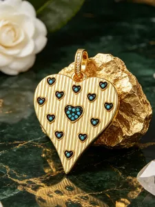 Detailed view of gold heart pendant with vertical stripes and colorful zircon inlay charm.