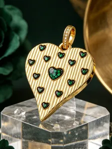 Gold heart pendant with vertical texture and green zircon stones for DIY jewelry making detail.