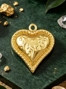 Gold heart pendant DIY jewelry accessory with embossed floral pattern and vintage beaded border.