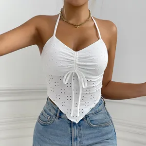 White halter crop top with eyelet embroidery, front drawstring and irregular hem.