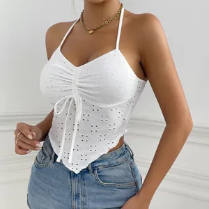 White eyelet halter crop top featuring front drawstring and irregular hemline details.