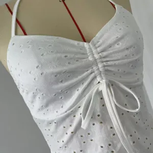 White halter neck camisole top with eyelet embroidery and front drawstring ruching detail.