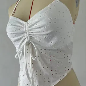 White halter lace-up camisole with eyelet embroidery and stylish asymmetric hem for women.
