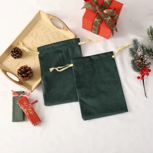 Green velvet gift bags detail view, soft pouch with golden drawstring for jewelry and holiday candy.