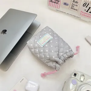 Korean style quilted polka dot drawstring pouch for camera and cosmetics storage detail view.