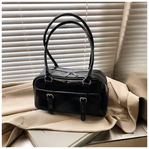 Black oil wax leather shoulder bag detail, stylish pillow tote with double handles.
