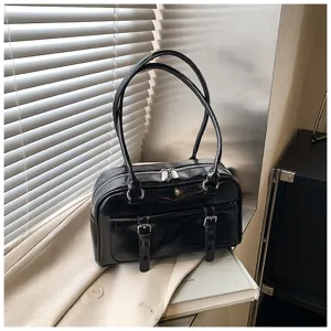 Black oil wax leather shoulder bag detail, stylish pillow shape with dual straps and pockets.