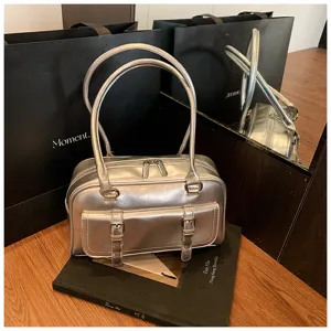 Silver metallic leather shoulder bag featuring dual top handles and front pocket buckle strap details.