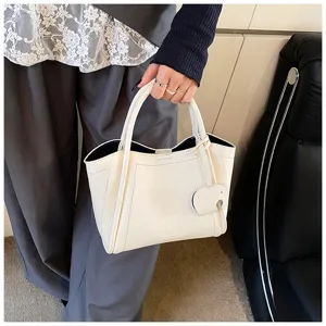 White soft leather bucket handbag detail showcasing elegant design, smooth texture, and chic style.