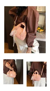 Detailed view of the chic pink patent leather handbag with lace pearl bow for women.