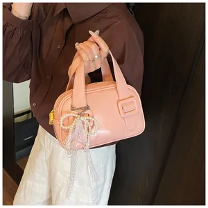 Chic pink soft leather handbag for women, stylish tote and crossbody pillow bag with pearls.