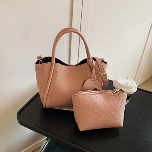 Stylish pink leather tote bag set with matching pouch, perfect for daily casual commuting.