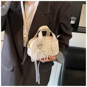 Chic soft leather crossbody bag for women, stylish pillow handbag with pearl lace charm.