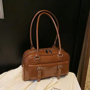 Brown patent leather shoulder bag, commuter pillow bag with double straps and front pockets.