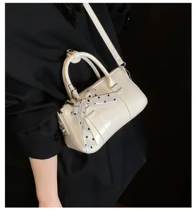 Stylish minimalist shoulder bag for women, retro casual commuter handbag with chic bow.