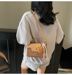 Chic style leather straw woven messenger bag with cute bear charm for daily use.